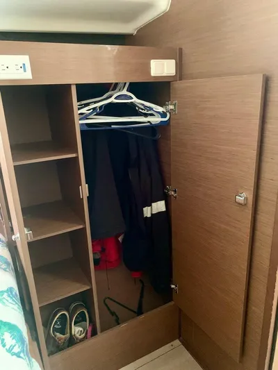 Esperanza Yacht Photos Pics Wooden closet interior on 2019 Lagoon 380 S2 4/2 yacht, with shelves and hanging space.