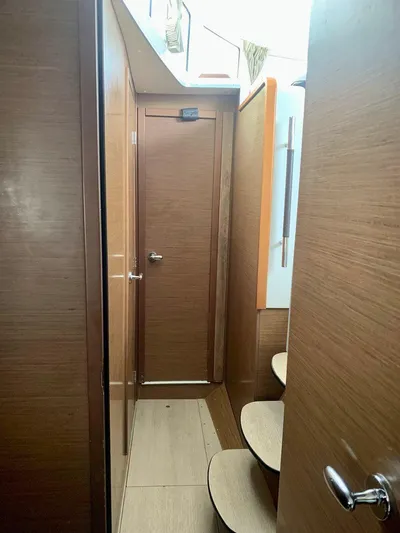 Esperanza Yacht Photos Pics Interior hallway of 2019 Lagoon 380 S2 4/2 catamaran with wooden finish and steps.