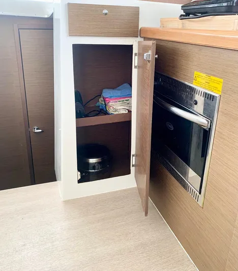 Esperanza Yacht Photos Pics 2019 Lagoon 380 S2 yacht interior with wooden cabinetry and built-in oven.