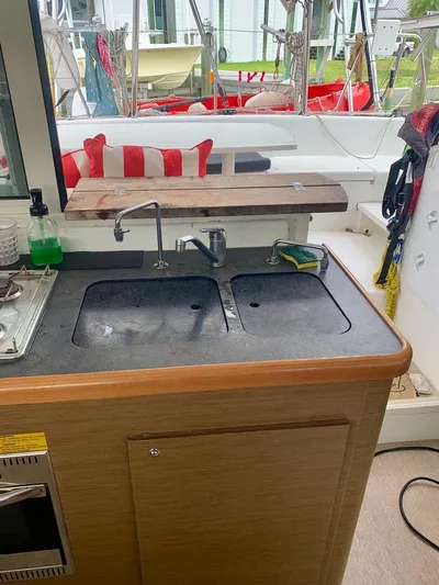 Esperanza Yacht Photos Pics Kitchen area on a 2019 Lagoon 380 S2 4/2 catamaran with dual sinks and outdoor view.