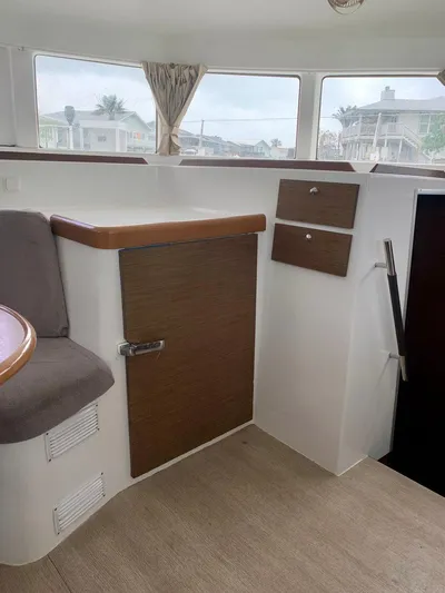 Esperanza Yacht Photos Pics Interior of 2019 Lagoon 380 S2 4/2 catamaran with wood accents and seating.