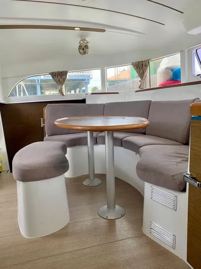 Esperanza Yacht Photos Pics Interior of 2019 Lagoon 380 S2 4/2 catamaran with cozy seating and round table.