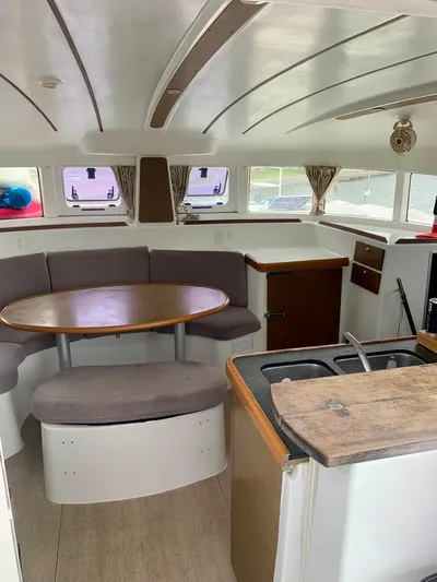 Esperanza Yacht Photos Pics Interior of 2019 Lagoon 380 S2 4/2 catamaran with dining area and kitchenette.