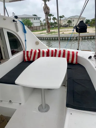 Esperanza Yacht Photos Pics Outdoor seating area on 2019 Lagoon 380 S2 4/2 catamaran with striped cushions.