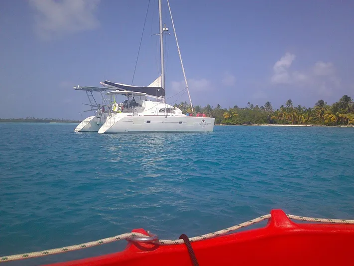 Esperanza Yacht Photos Pics 2019 Lagoon 380 S2 catamaran anchored near tropical island with clear blue water.