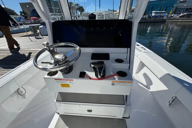  Yacht Photos Pics 2025 Sportsman Masters 267OE Bay Boat helm with steering wheel and controls.