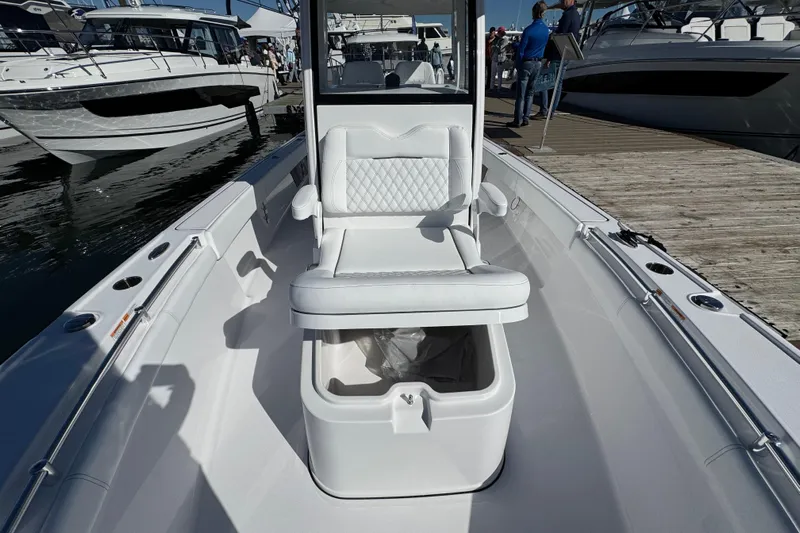 Yacht Photos Pics 2025 Sportsman Masters 267OE Bay Boat interior with seating and storage, docked at marina.