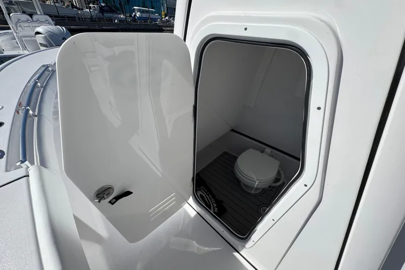  Yacht Photos Pics 2025 Sportsman Masters 267OE Bay Boat with open compartment showing interior toilet.