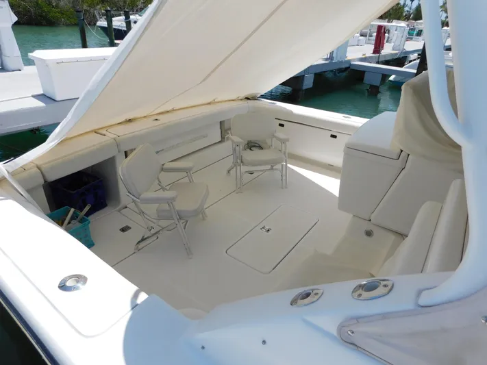 Cap & Dan Yacht Photos Pics 2001 Tiara Yachts 3800 Open cockpit with seating and canopy, docked at marina.