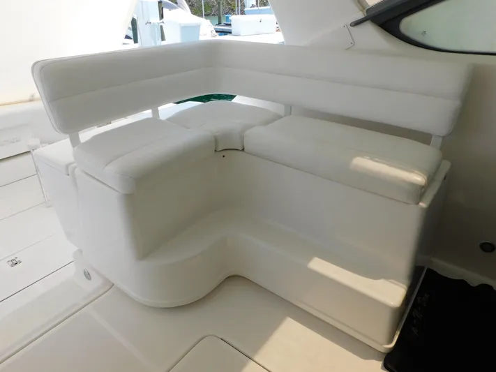 Cap & Dan Yacht Photos Pics 2001 Tiara Yachts 3800 Open interior seating, featuring white cushioned L-shaped design.
