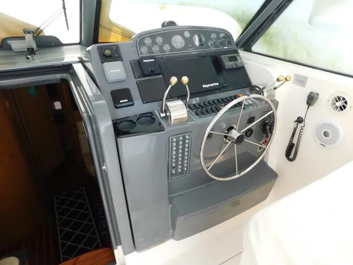 Cap & Dan Yacht Photos Pics 2001 Tiara Yachts 3800 Open helm with steering wheel and navigation controls.