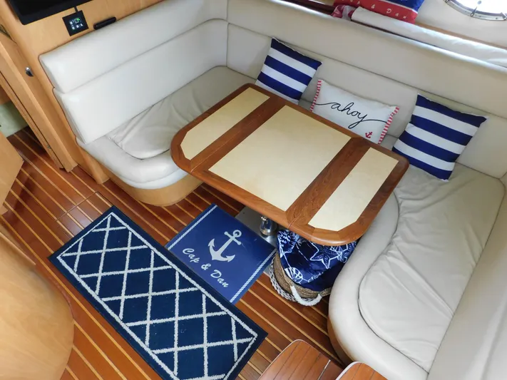 Cap & Dan Yacht Photos Pics 2001 Tiara Yachts 3800 Open interior with cozy seating and nautical decor.