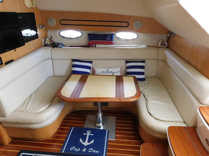 Cap & Dan Yacht Photos Pics Interior of 2001 Tiara Yachts 3800 Open with cozy seating and nautical decor.