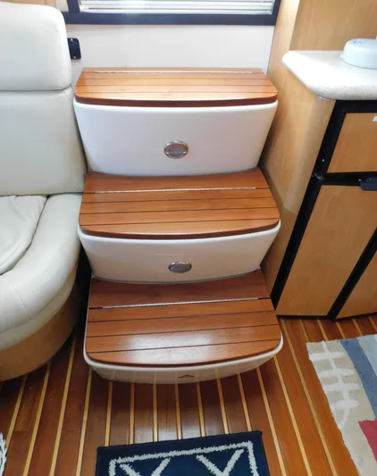 Cap & Dan Yacht Photos Pics Wooden steps inside a 2001 Tiara Yachts 3800 Open, featuring elegant design and craftsmanship.