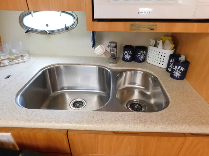 Cap & Dan Yacht Photos Pics 2001 Tiara Yachts 3800 Open kitchen sink with dual basins and countertop accessories.