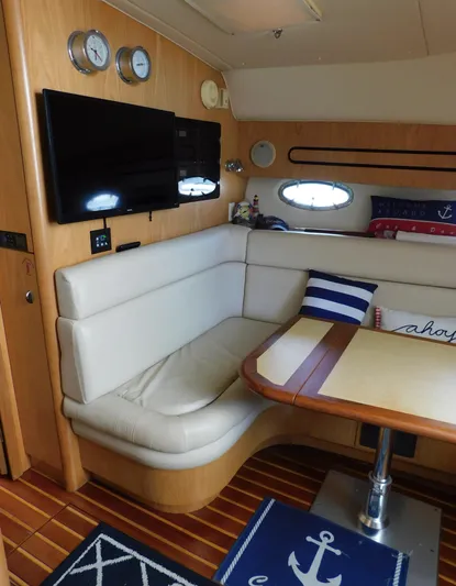 Cap & Dan Yacht Photos Pics Interior of 2001 Tiara Yachts 3800 Open with cozy seating and nautical decor.