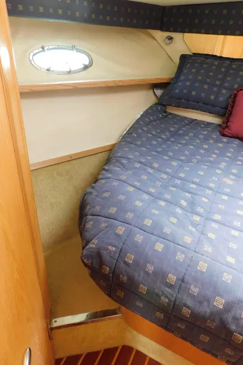 Cap & Dan Yacht Photos Pics 2001 Tiara Yachts 3800 Open cabin with cozy bed and porthole window.