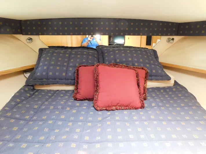 Cap & Dan Yacht Photos Pics Cozy cabin bed in 2001 Tiara Yachts 3800 Open with decorative pillows.