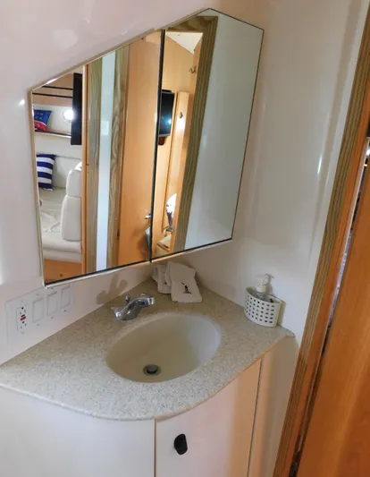 Cap & Dan Yacht Photos Pics 2001 Tiara Yachts 3800 Open bathroom with sink, mirror, and soap dispenser.