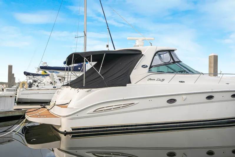 Decadance Yacht Photos Pics 2003 Sea Ray 460 Sundancer yacht docked at marina under clear blue sky.