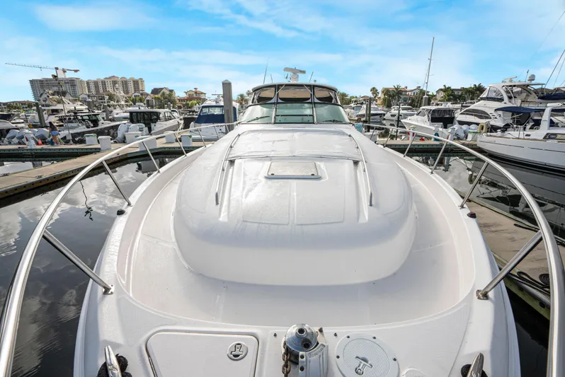Decadance Yacht Photos Pics 2003 Sea Ray 460 Sundancer yacht docked at a marina under a clear blue sky.