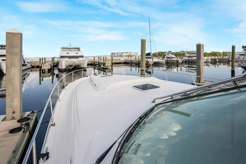 Decadance Yacht Photos Pics 2003 Sea Ray 460 Sundancer docked in a marina under a clear blue sky.
