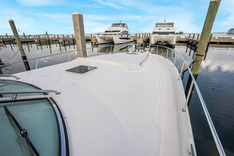 Decadance Yacht Photos Pics 2003 Sea Ray 460 Sundancer yacht docked at marina with clear blue sky.