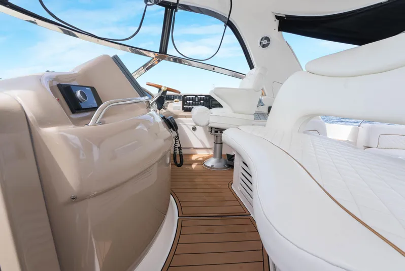 Decadance Yacht Photos Pics Interior of 2003 Sea Ray 460 Sundancer yacht with luxurious seating and modern controls.
