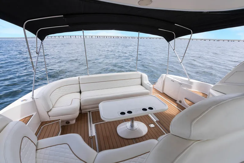 Decadance Yacht Photos Pics 2003 Sea Ray 460 Sundancer yacht interior with white seating and ocean view.