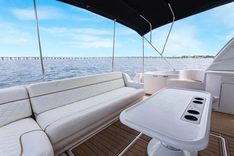Decadance Yacht Photos Pics 2003 Sea Ray 460 Sundancer yacht deck with white seating and ocean view.