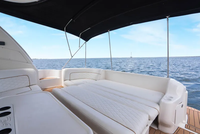 Decadance Yacht Photos Pics 2003 Sea Ray 460 Sundancer yacht interior with cushioned seating and ocean view.