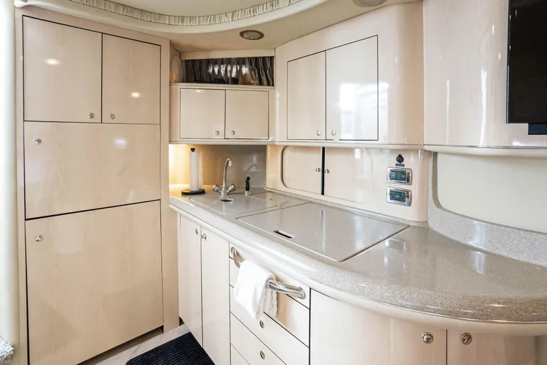 Decadance Yacht Photos Pics Luxurious kitchen interior of 2003 Sea Ray 460 Sundancer yacht with modern cabinetry.
