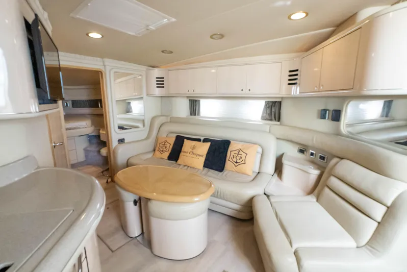 Decadance Yacht Photos Pics Luxurious interior of 2003 Sea Ray 460 Sundancer yacht with plush seating and elegant design.