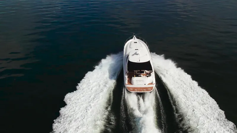 Decadance Yacht Photos Pics 2003 Sea Ray 460 Sundancer yacht cruising on open water, aerial view.