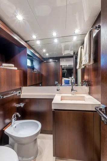Easy Yacht Photos Pics Luxurious bathroom in 2009 Sanlorenzo 82 yacht with modern fixtures and wood accents.