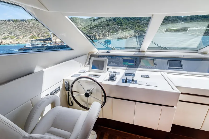 Easy Yacht Photos Pics Helm of 2009 Sanlorenzo 82 yacht with modern navigation equipment and panoramic windows.