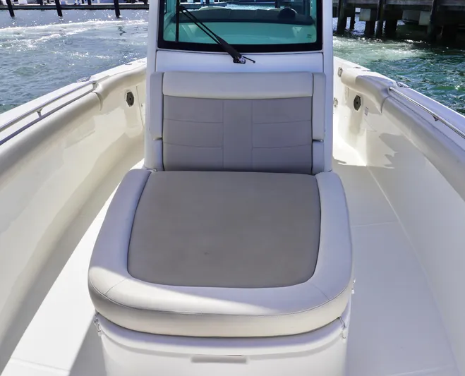 Vasea Yacht Photos Pics 2021 Boston Whaler 330 Outrage boat interior with cushioned seating.