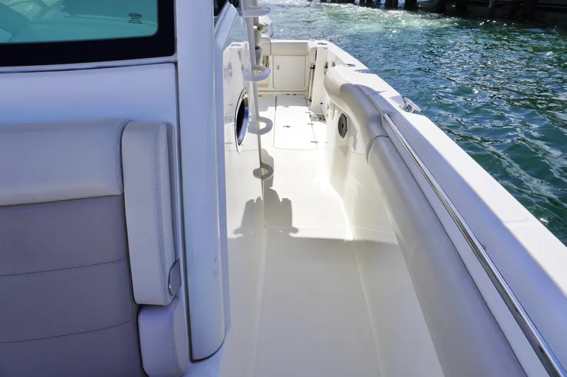 Vasea Yacht Photos Pics 2021 Boston Whaler 330 Outrage boat deck with sleek design and water view.