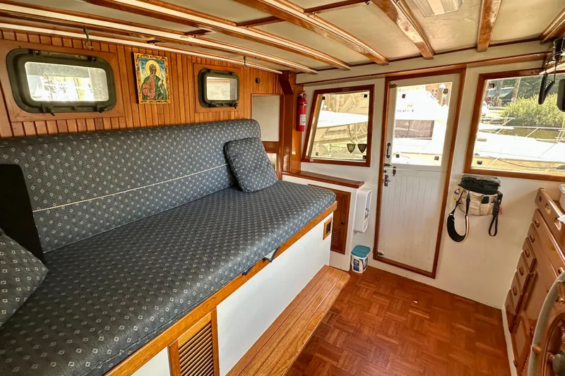  Yacht Photos Pics Interior of 1983 Kadey-Krogen Krogen 42 Trawler with wooden accents and cushioned seating.