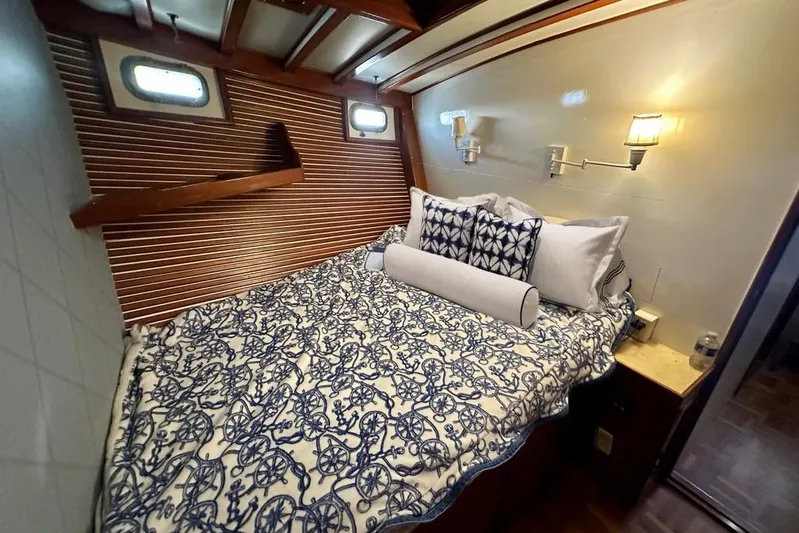  Yacht Photos Pics Cozy cabin interior of 1983 Kadey-Krogen Krogen 42 Trawler with nautical bedding and warm lighting.