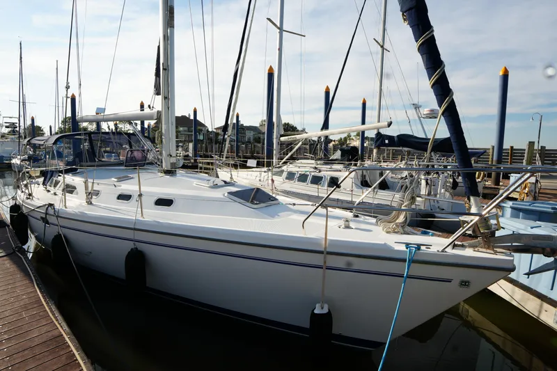 Summer Breeze Yacht Photos Pics 2002 Catalina 42 Mark II sailboat docked at marina under clear sky.
