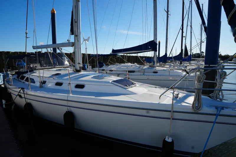 Summer Breeze Yacht Photos Pics 2002 Catalina 42 Mark II sailboat docked in a marina under clear blue skies.