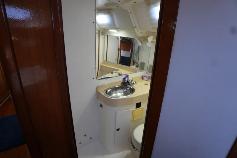 Summer Breeze Yacht Photos Pics Interior of 2002 Catalina 42 Mark II yacht bathroom with sink and mirror.