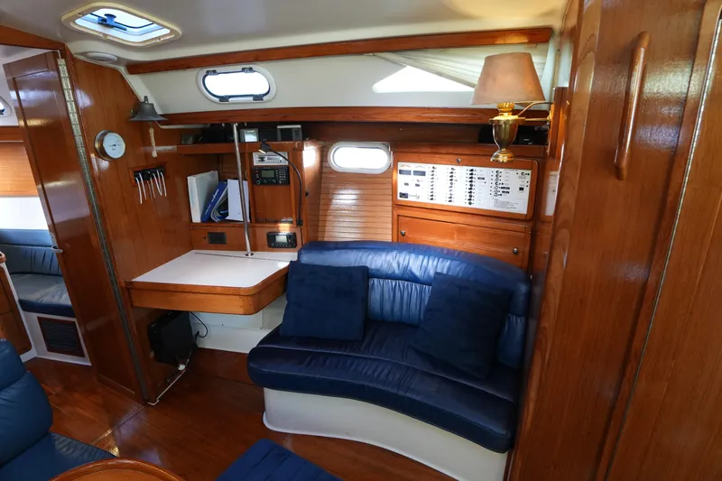 Summer Breeze Yacht Photos Pics Interior of 2002 Catalina 42 Mark II sailboat with wood paneling and blue seating.