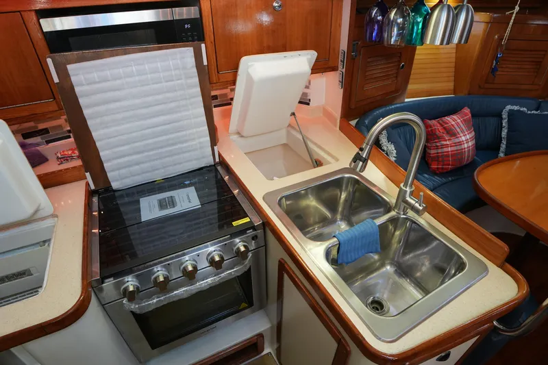 Summer Breeze Yacht Photos Pics Galley kitchen in 2002 Catalina 42 Mark II yacht with stove and double sink.