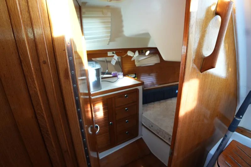 Summer Breeze Yacht Photos Pics Interior cabin of 2002 Catalina 42 Mark II sailboat with wooden finish and cozy bed.