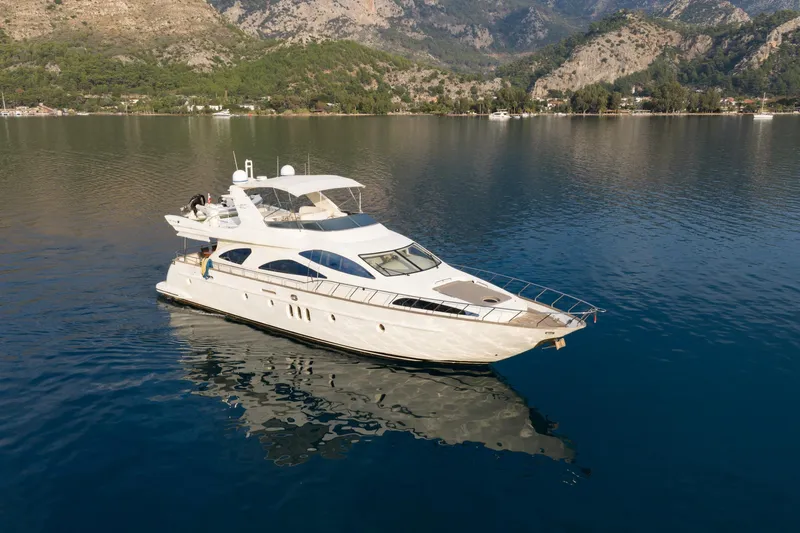 Senior S Yacht Photos Pics Luxury 2004 Azimut 80 yacht cruising on serene waters with mountainous backdrop.
