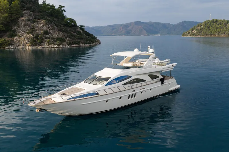 Senior S Yacht Photos Pics Luxury 2004 Azimut 80 yacht cruising in serene waters near lush, rocky islands.