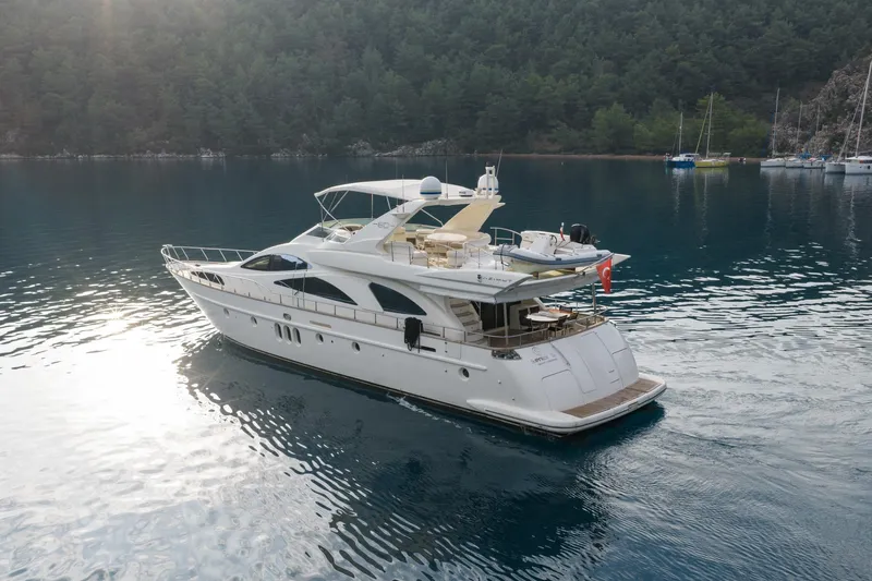 Senior S Yacht Photos Pics Luxury 2004 Azimut 80 yacht cruising on serene waters, surrounded by lush greenery.
