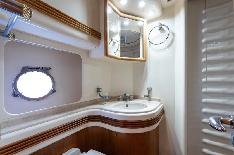 Senior S Yacht Photos Pics Luxurious bathroom interior of 2004 Azimut 80 yacht with elegant fixtures and porthole window.